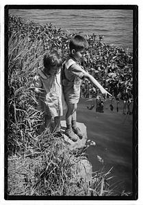 Children by a body of water