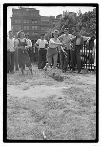 Two young women playing horseshoes
