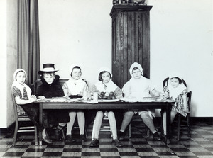 Seated at a table in costume - Perkins School for the Blind
