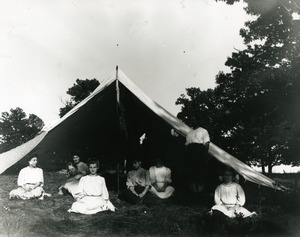 People in front of large tent
