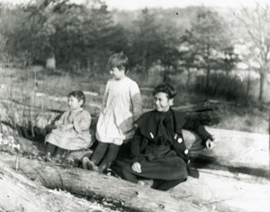 Trio near pond and logs