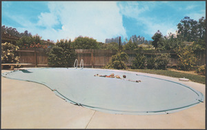 Two people on top of cover on an in-ground swimming pool