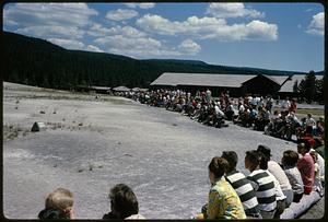 People sitting in semicircle waiting for geyser to erupt, Yellowstone National Park