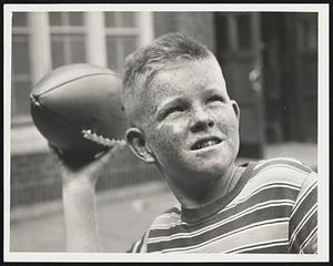 What if it was 96 Yesterday? There's football just ahead, as shown by John McCallion, 11. He won the football for being judged "\Champion Freckle-Face" in the Charlestown Boys' Club annual contest.