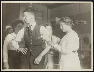 Story coming from Savior Inoculate against influenza at laboratory of the state department of health. The subject and Miss Helen Gillette asses that bacteriologist, who is administering the serum