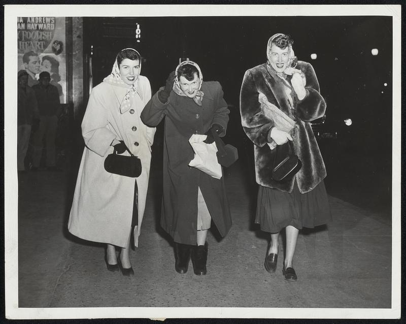 And It Will Be Cold Today, Too - Braving the frigid blasts of the north wind in downtown Boston last night were Joan Ardini of Revere, and Mary O'Connor and Jerry O'Brien of Arlington, left to right.