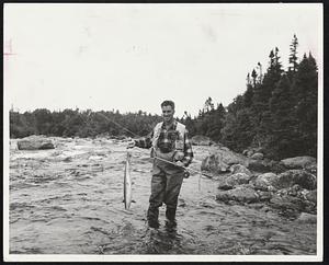 Landing a salmon like this would bring a smile to the face of any angler. The lucky man is Lee Wulff of New Hampshire.