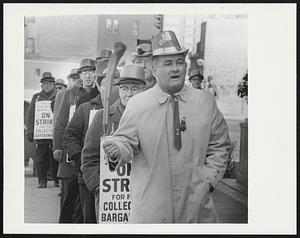 Boston: St. Patrick's Day Picket Line... swinging a shilalelagh Leo T. O'Hare of No.Weymouth, Mass., leads strikers, all wearing green hats, on picket line outside the Herald-Traveler news plant (3/17). The strike that has struck Baton's five daily newspapers enter its 12th day.