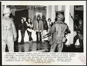 Taking Control at Bayonet Point -- National Guardsmen with fixed bayonets take custody of young people who failed to leave the streets just outside the University of California at Santa Barbara campus last night. Several hundred soldiers moved in after three nights of rioting.