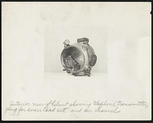 Interior view of helmet showing telephone transmitter, plug for divers head set and air channel