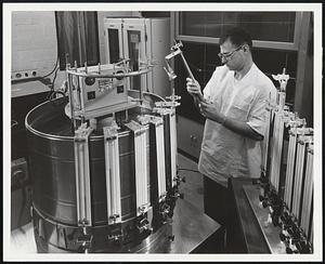 A sensitive way to determine the activity of a microorganism is to measure its respiration. Dr. George L. Ellman is shown here using a Warburg microrespirometer for this purpose.