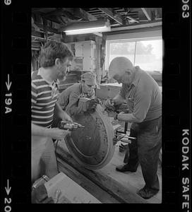 Men working in Pert Lowell's boat shop