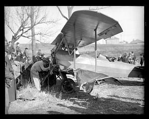 People examining a wrecked airplane