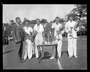 John van Ryn, Wilmer Allison, Gene Mako and Donald Budge being presented with cups at a ceremony