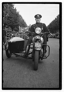 A police officer on a motorcycle with a sidecar