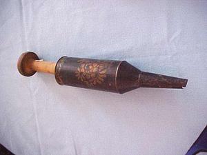 Metal implement with a flower design