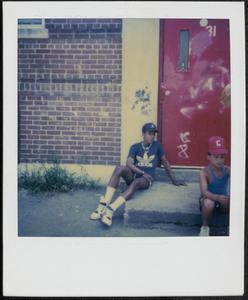 Kymio and a friend sitting in Newtowne Court