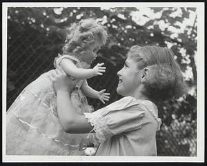Up, You Beautiful Doll--And the doll looks almost as delighted as Marjorie Heap, 10, who won first prize for the prettiest doll at the annual show at the South Boston Girls' Club.
