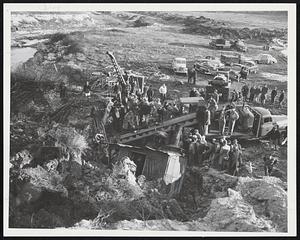 Death in Landslide-Rescue workers down in cab of toppled power shovel struggle to break through to Belmont workman who was buried alive in Cambridge clay pit.