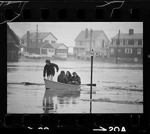 After flooding, locals travel streets by boat, Scituate