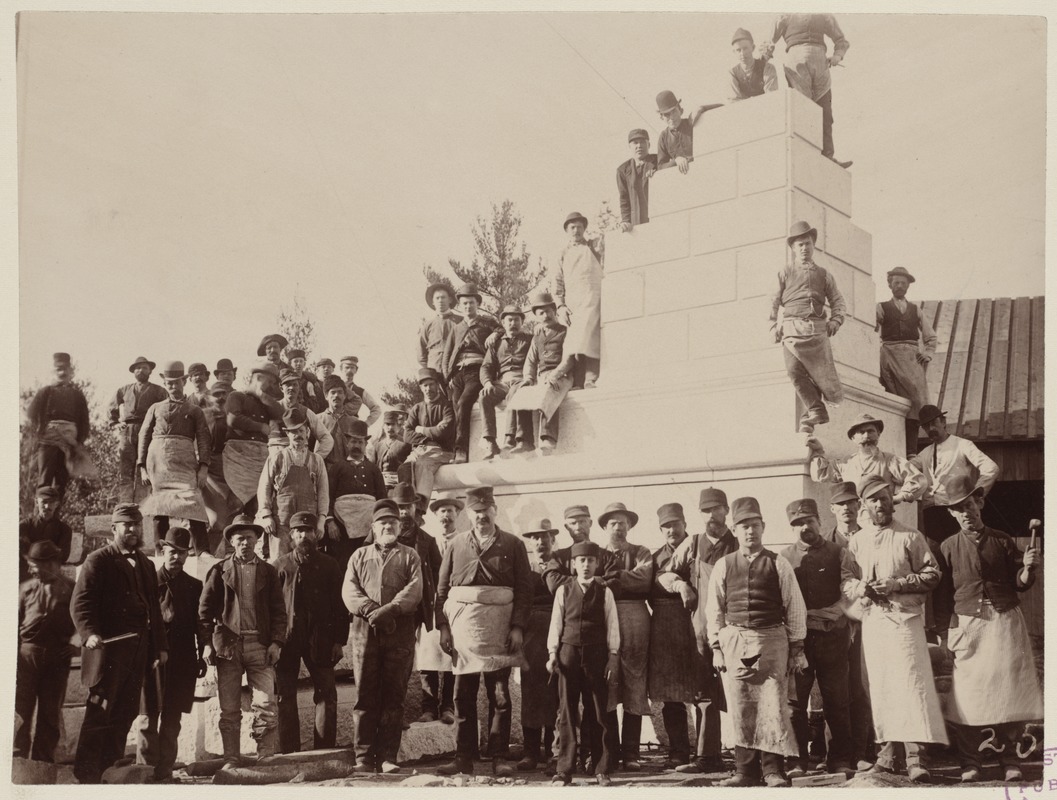 Milford Quarry workmen surround mock-up of cornerstone of McKim Building