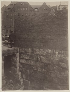 Brick interior wall on foundation along South side of site, construction of the McKim Building