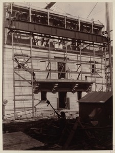 East wall of courtyard showing girder being raised, construction of the McKim Building