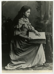Portrait of Helen Keller reading a braille book