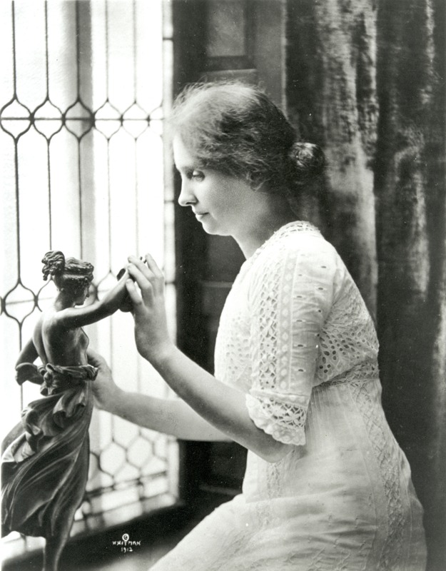 Helen Keller investigating statue