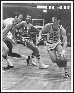 Infraction. Right, Larry Siegfried gets by Chicago guard Clem Haskins (10) on drive taking shot over Barry Clemens (left).