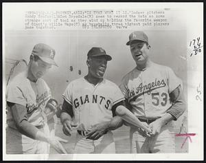 “Is That What it is.” Dodger pitchers Sandy Koufax(L)&Don Drysdale(R) seem to regard the bats as some strange sort of tool as they wind up holding the favorite weapon of Giant’s Willie Mays(C) as baseballs three highest paid players pose together.