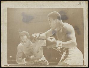 Cassius Clay lands a punch on challenger Zora Folley during their championship fight 3/22.
