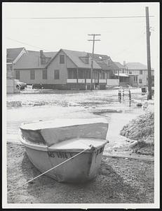 Almost Floated by flood waters at Peggoty Beach in Scituate is this boat tied up beside owner's home. It was second straight day cottages and waterfront properties were damaged in wake of storm.