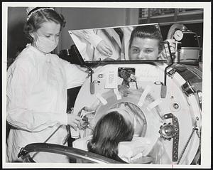 She's Different- Miss Marjery Foye, 22, who specializes in respirator nursing at Haynes Hospital, is shown with a patient, Mrs. Lily S. Manning, 321 mother of two children and wife of Dr. john E. Manning, Fall River pediatrician.