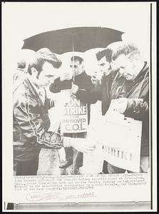 Keeping Warm on the Picket Line--United Auto Workers picketing the General Motors assembly plant at Framingham, Mass., brace themselves with hot coffee Tuesday morning as temperatures dropped to the mid-fifties accompanied by a cold drizzle.