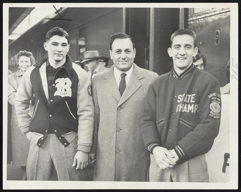 Entraining for Southern Game at South Station yesterday were coach Frank Saba (center) and Co-Captains Bob Flanagan (left) and Armand Colombo Who will lead Brockton High against Edison High of Miami, Fla, in the post-season game at Miami Friday night.