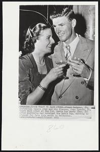 A Toast to Each Other--Frank Sedgman, 24, Australian tennis star and his fiancée, Jean Spence, 21, toast each other at the U.S. Davis Cup party (Dec. 28) after Australia had retained the Davis Cup. Wedding is planned for late this month in Melbourne.