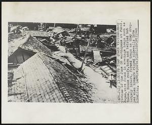 Roofs Trap Quake Victims- Many victims of the June 28 earthquake at Fukui, Japan, were found in wreckage heaps such as these. House roofs, torn and twisted but largely intact, formed traps as they dropped when tremors ripped sidewalls into kindling.