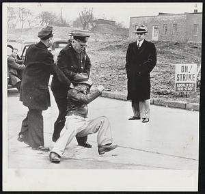 Struggle On Picket Line -- Pickets tried to stop a back-to-work movement at Fawick Airflex Co., Cleveland. Patrolman Naperta (left) and Police Chief James block Morris Stamm, chief shop steward of the CIO-United Electrical Workers. On the right is R.S. Huxtable, company general manager.