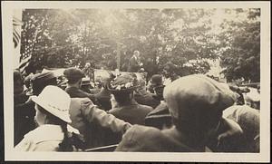 Outdoor audience listening to speaker on podium