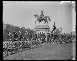 Parade of soldiers marching past statue of George Washington, Boston Public Garden