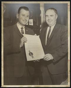 Dodge Boy Honored. House Resolution adopted unanimously honors Herbert A. Abramson, left, president of Silver Lake Motors. Resolution is presented to Newton Dodge dealer by Speaker John Davoren. Abramson won the Grand National Benjamin Franklin Quality Dealer Award from Saturday Evening Post and National Automobile Dealer Association.