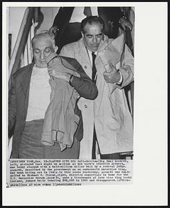 Slapped with Big Bail--Settimo (Big Sam) Accardi, left, pictured last night on arrival at New York’s Idlewild Airport, was today slapped with a half-million dollar bail by a Federal judge. Accardi, described by the government as an underworld narcotics king, had been hiding out in Italy. In this scene yesterday, Accardi was handcuffed to Michael G. Picini, right, district supervisor in Rome for the U.S. Narcotics Bureau. Accardi, once a lieutenant of late vice king Lucky Luciano, jumped bails totaling $92,500 in 1955 and disappeared.