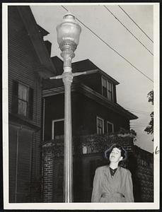 “Don’t Tear Down Our Gas Lights, Mister,” says Pauline Mulqueeny of Exeter place. Cambridge, who adds that the old-fashioned wrought iron lamps are historical and “go with the surroundings.”