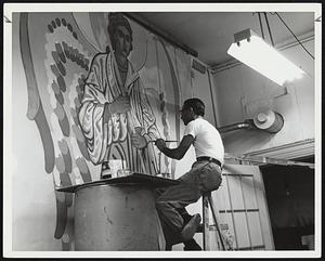 A man painting an angel on a wall