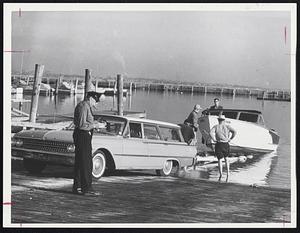 Boat being towed out of water owned by Gene Martin of Norwood