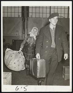 Immigrants Find Haven In U.S. These two immigrants were among the passengers arriving in New York, Nov. 17 on the liner queen Mary from troubled Europe. The man, in foreground (unidentified) carries his worldly goods in a small suitcase, while the woman, Margaret Lubac, from Prague, Czechoslovakia, comes ashore in her native costume with a large bundle.