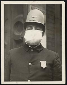 Boston patrolman, shown here in 1918 photo, wearing his face mask as protection against influenza outbreak which swept the country.
