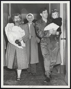 Winthrop Flood Refugees - S-Sgt. and Mrs. Archie Johnson, carrying Charlotte, seven months, and Virgil, with Mrs. John Clark, wife of a Fort Banks major, who took the Johnsons into their home.