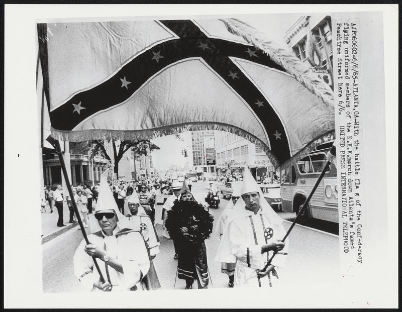 With the battle flag of the Confederacy flying uniformed members of the K.K.K.march down Atlanta’s famed Peachtree Street here 6/6.